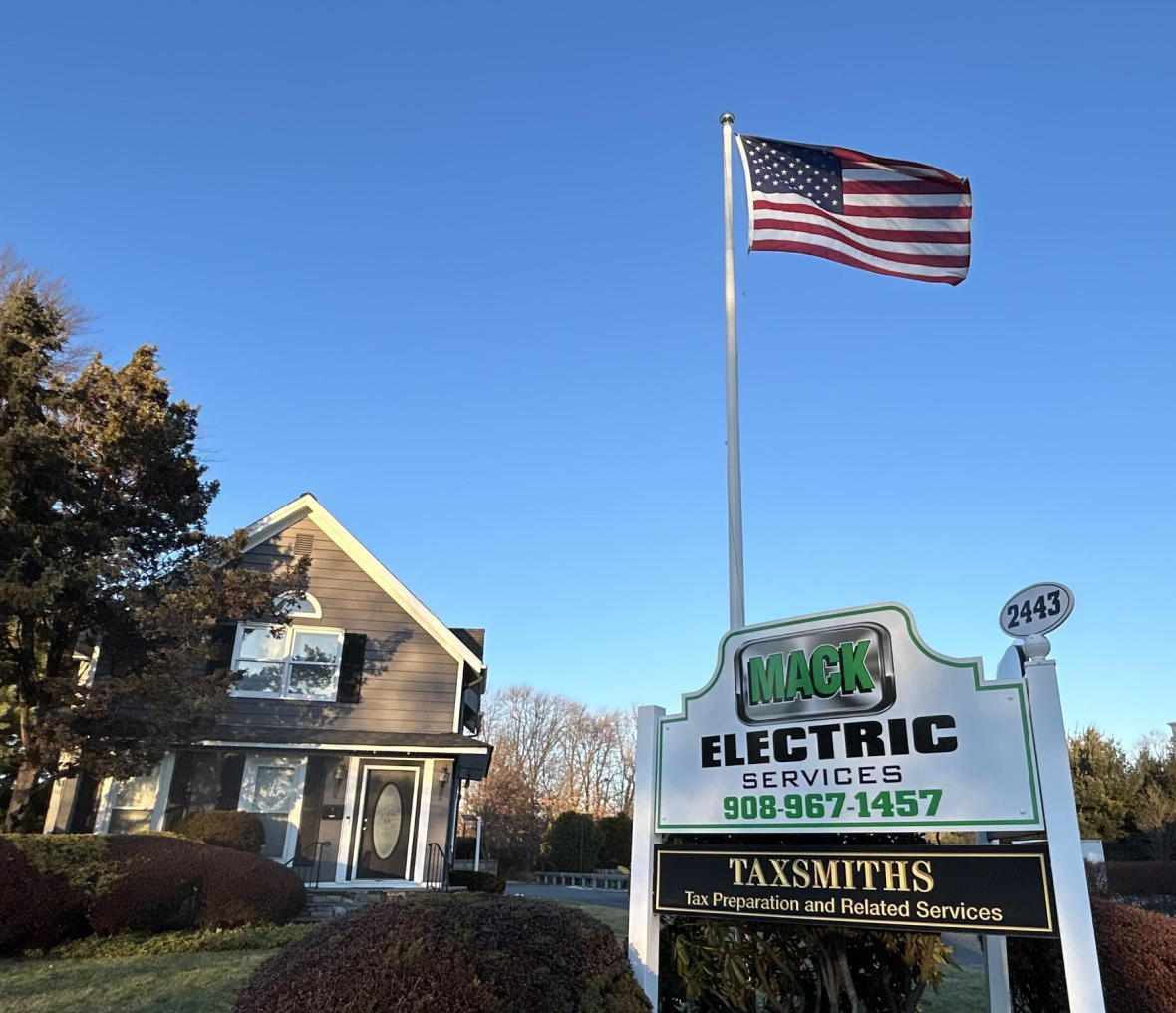 American flag near Mack Electric Services sign